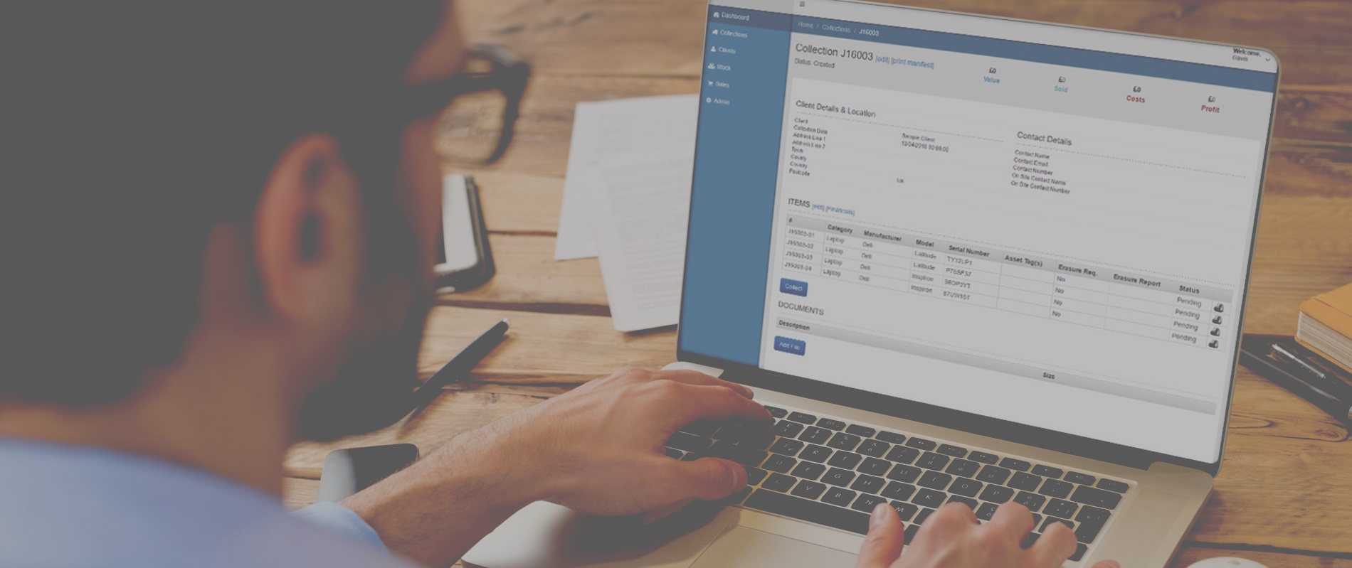 Image of a worker usign their laptop to check the details of a collection